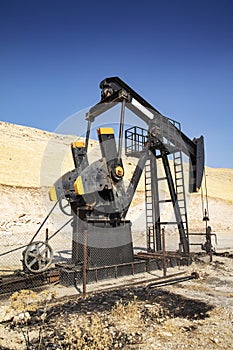 Oil drilling derricks at desert oilfield.