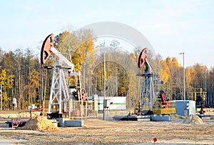 Oil drilling derricks at desert oilfield. Crude oil production from the ground. Oilfield services contractor. Oil drill rig and photo