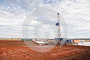 Oil Drilling Rig and Empty Mud Pond