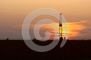 Oil Drilling Rig and Sunset