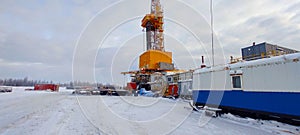 Oil drilling rig. Winter at dawn in the snow