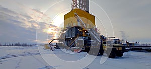 Oil drilling rig. Winter at dawn in the snow