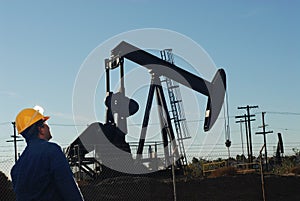 Oil drilling worker at oil field photo