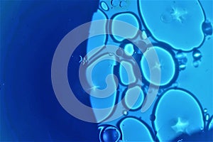 Oil drops on blue abstract background.stock photo