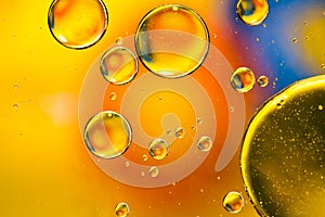 Oil drops in water, bubbles on orange abstract background