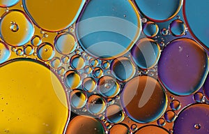 Oil drops on a water surface with brillant colors Abstract background image