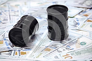 Oil drums on US dollars background