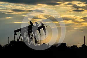 Oil field beam pump in shadow.