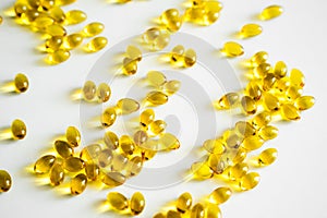 Oil filled capsules, softgel of food supplements. Vitamin D3. Yellow softgels, top view, copy space. Nutritional