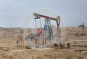 Oil and gas drilling rig onshore dessert with dramatic cloudscape . Land oil drilling rig blue sky .Land rig during the