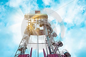 Oil and Gas Drilling Rig onshore dessert with dramatic cloudscape. Oil drilling rig operation on the oil platform in oil