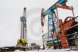 Oil and Gas Drilling Rig onshore dessert with dramatic cloudscape. Oil drilling rig operation on the oil platform in oil and gas