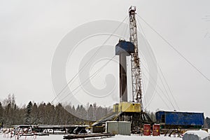 Oil and Gas Drilling Rig onshore dessert with dramatic cloudscape. Oil drilling rig operation on the oil platform in oil and gas