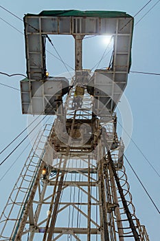 Oil and Gas Drilling Rig onshore dessert with dramatic cloudscape. Oil drilling rig operation on the oil platform in oil and gas