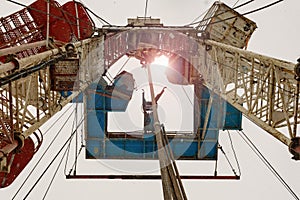 Oil and Gas Drilling Rig onshore dessert with dramatic cloudscape. Oil drilling rig operation on the oil platform in oil and gas