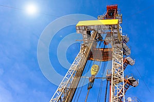 Oil and Gas Drilling Rig onshore dessert with dramatic cloudscape. Oil drilling rig operation on the oil platform in oil and gas