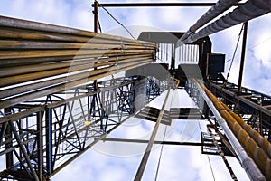 Oil and Gas Drilling Rig onshore dessert with dramatic cloudscape. Oil drilling rig operation on the oil platform in oil and gas