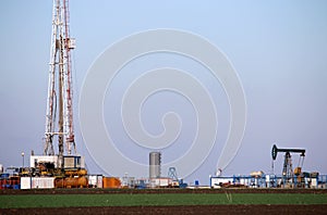 Oil and gas drilling rig and pump jack in oilfield