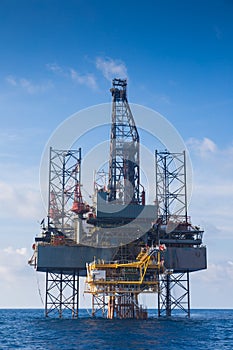 Oil and gas drilling rig work over remote wellhead platform to completion oil and gas produce well