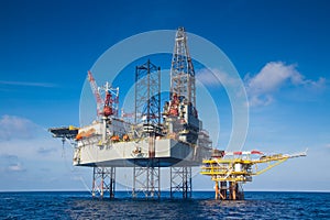 Oil and gas drilling rig work over remote wellhead platform to completion oil and gas produce well