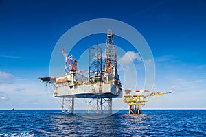 Oil and gas drilling rig work over remote wellhead platform to completion oil and gas produce well