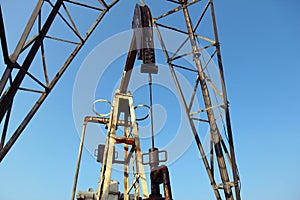 Oil and gas industry. Crude oil mining pump under blue sky