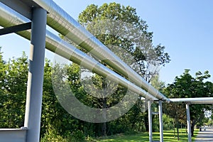 Oil and Gas Industry external pipelines among green trees and lawn, heating main photo