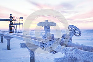 Oil, gas industry. Group wellheads and valve armature, gas production process, pipe fittings, valves in frost in the frost