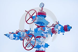 Oil, gas industry. Group wellheads and valve armature ,Gas well of high pressure; gas production process, shooting in the snow