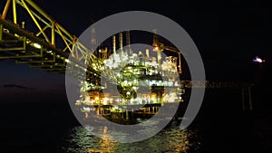 Oil and gas industry and hard work at night time. Offshore construction platform