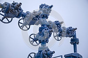 Oil, gas industry. High pressure gas well, pipe fittings, valves in frost in the frost