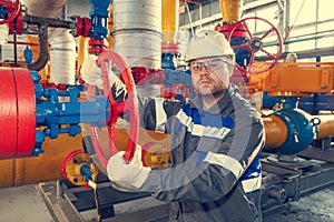 Oil, gas industry. The mechanic - the repairman, gas production operator opens the valve, gas equipment and fitting, toned
