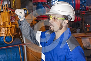 Oil, gas industry. The mechanic - the repairman, gas production operator opens the valve, gas equipment and fitting, toned