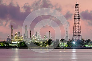 Oil and gas industry refinery, river skyline in the morning