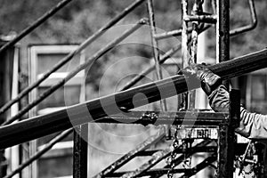 Oil and gas industry worker operates oil rig drill pipes on an oil well rig