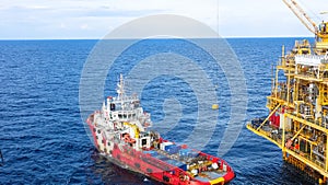 Oil and Gas processing platform,crane lifting cargo to loading to supply boat