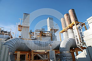 Oil and gas production process with the machine or turbine unit. The exhaust line of the engine on oil and gas platform.