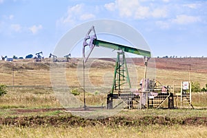 Oil and gas pump in action, industrial fuel oilwell, oilfield