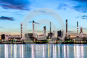 Oil and gas refinery industry plant with glitter lighting and sunrise in the morning,