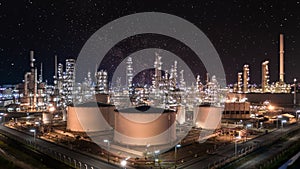 Oil and gas refinery plant and storage tank form industry zone at night sky with star, Aerial view oil and gas Industrial