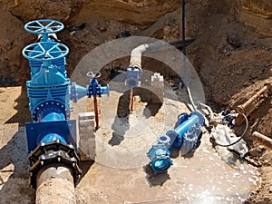 Oil, gas, water industry. Wellhead with valve armature underground. Dug deep trench