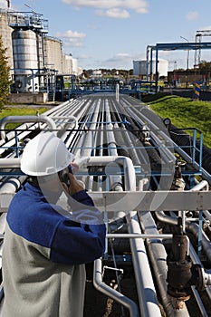 Oil and gas worker in front of refinery