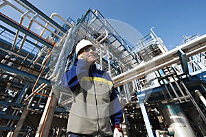 Oil and gas workers in front of refinery