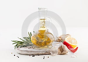 Oil with herbs in the bottle of salad on white