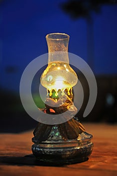 An oil lamp is burning on a table