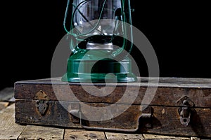 Oil lamp in an old wooden case. Old accessories set on a wooden