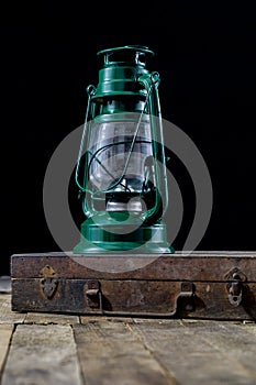 Oil lamp in an old wooden case. Old accessories set on a wooden