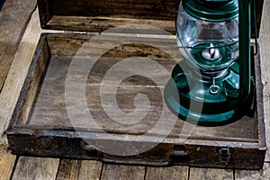 Oil lamp in an old wooden case. Old accessories set on a wooden