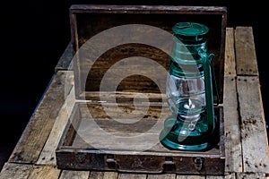 Oil lamp in an old wooden case. Old accessories set on a wooden