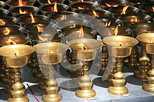 Oil lamps were put on a table in the courtyard of a buddhist temple (China) photo